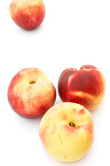Heap of ripe raw beautiful colorful red yellow nectarines isolated with shadow on white background. Summer fruits vitamins harvest healthy lifestyle concept. Food poster with copy space