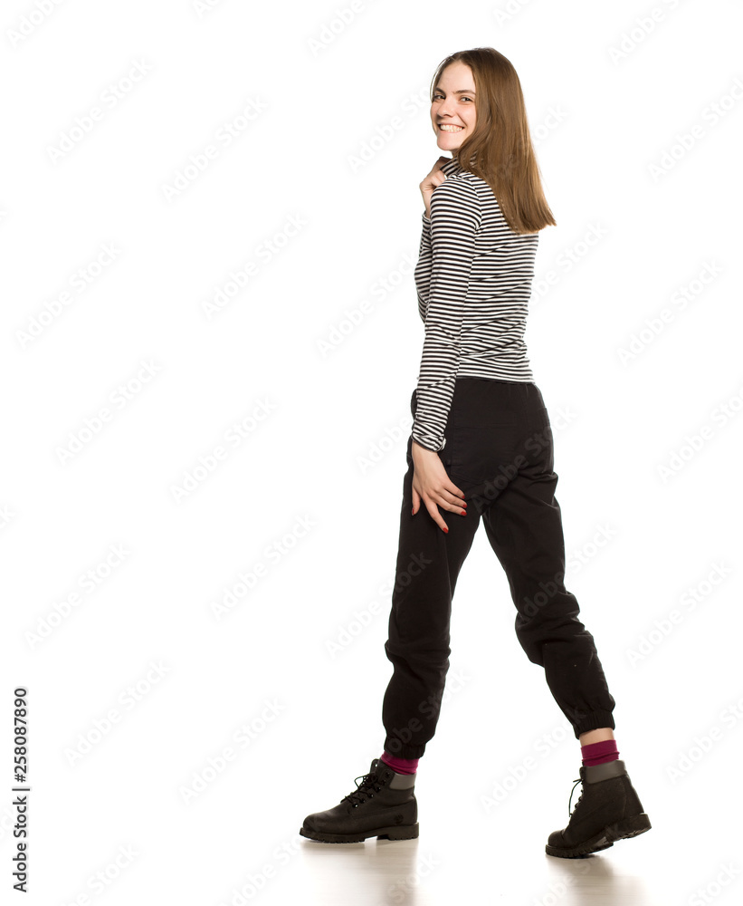 Poster Young woman in blouse walking on white background