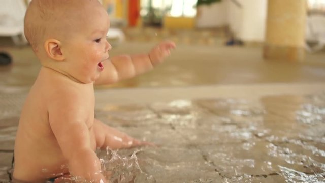 Baby splashing in the warm pool for kids. Strengthening immunity, the development of kids