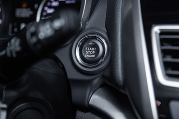 Fototapeta na wymiar Сlose-up of the car grey interior: start stop engine button.