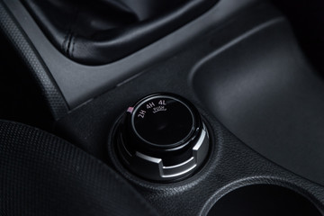 Сlose-up of the car  black interior,  4wd buttons