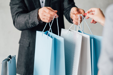 Shopping lifestyle. Modern family casual leisure. Couple with variety of paper bags.