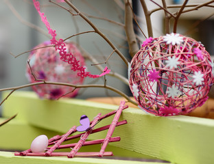 Easter decorations on the street of small town in France. Easter painted eggs and butterfly.