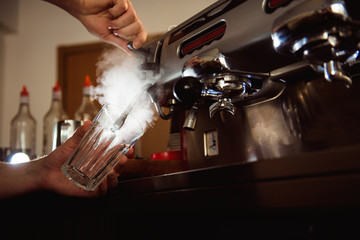 Close up barista hands making coffee cup with coffee machine in coffee shop