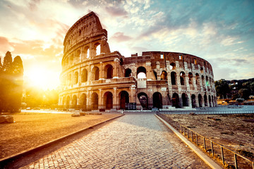 The ancient Colosseum in Rome at sunset - obrazy, fototapety, plakaty