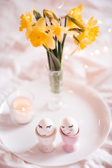 Easter eggs with funny face drawing in egg stands closeup. Good morning. Celebration.