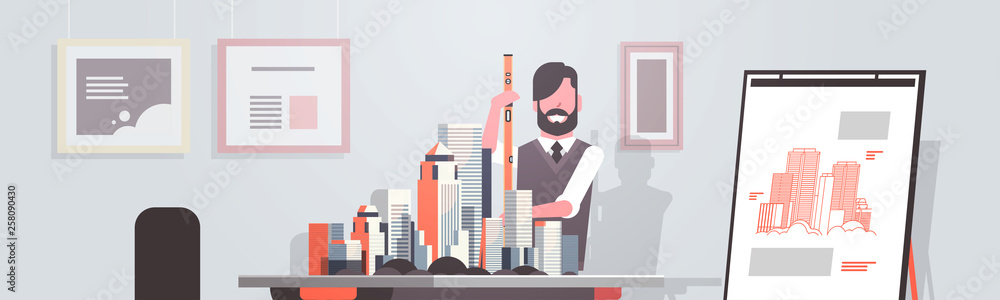 Aufkleber man architect holding level engineer working with new building city model for urban panning project 