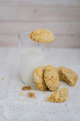 Oatmeal carrot cookies with nuts and milk close up selective focus