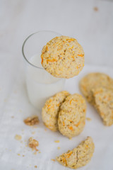 Oatmeal carrot cookies with nuts and milk close up selective focus