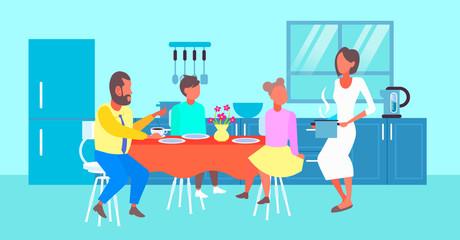 happy family having breakfast housewife serving food to her husband and children sitting at dinning table modern kitchen interior cartoon characters full length flat horizontal
