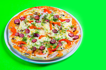 hot tasty fresh pizza on a plate close-up. green background