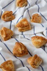 Homemade cottage cheese biscuits on cloth, side view. Selective focus.