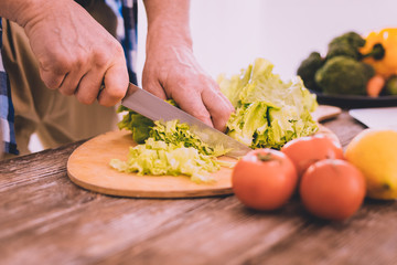 Talented cook preparing a fresh tasty salad