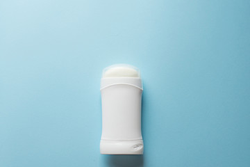 white deodorant on blue background. bath concept. place for text. copy space