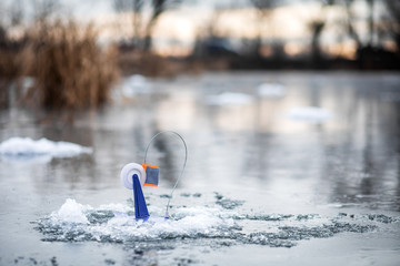 Naklejka premium Fishing tackle for winter fishing on the ice of a frozen lake