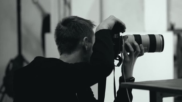 professional photographer takes a digital camera in a photo studio