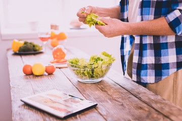 Inspired man preparing a dish with a salad
