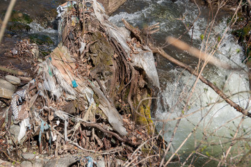 Plastic and foam garbage floating on the surface of the river