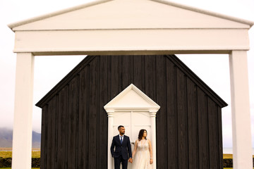 Beautiful wedding couple posing with black old church