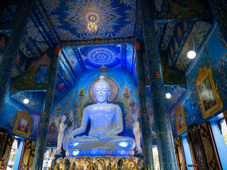White Buddha Sitting in The Blue Light at The Church
