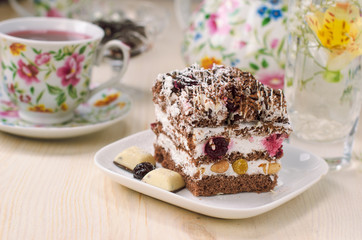Still life on the table. Sweet cake and a hot drink .