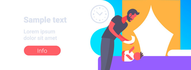 father cleaning up his baby son buttocks with wet napkin young man changing baby's diaper fatherhood childcare hygiene concept bedroom interior portrait horizontal copy space