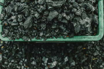 Outdoor drying charcoal texture and background. Close up dry charcoal. Dry charcoal on the ground that has already been used. Selective focus.