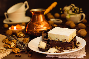 Still life on the table. Sweet cake and a hot drink .