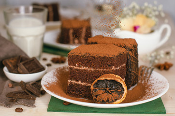 Still life on the table. Sweet cake and a hot drink . chocolate cake .