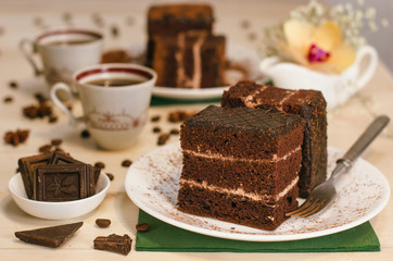 Still life on the table. Sweet cake and a hot drink . chocolate cake .