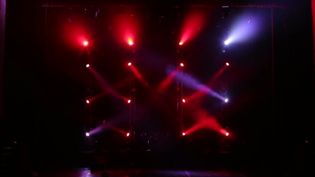 Colorful Stage lights at concert. Stage lights and smoke. Colored lights on an empty concert stage with smoke.