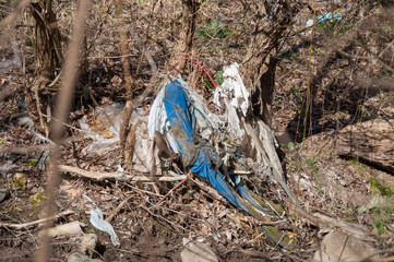 Plastic and foam garbage floating on the surface of the river