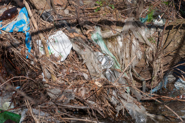 Plastic and foam garbage floating on the surface of the river
