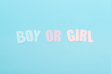 top view of boy or girl lettering isolated on blue with copy space