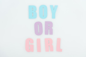 top view of pink, purple, blue boy or girl lettering isolated on white