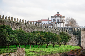 Fototapeta na wymiar The Walls of D. Fernando, or Fernandina Wall, with the Monastery of Serra do Pilar in the distance.