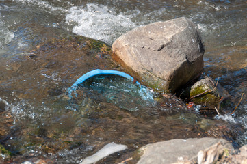 Plastic and foam garbage floating on the surface of the river