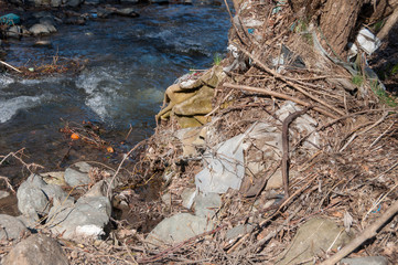 Fototapeta premium Plastic and foam garbage floating on the surface of the river
