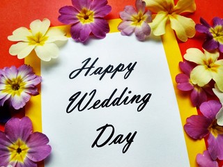 The inscription Happy Wedding Day with flowers on a colored background