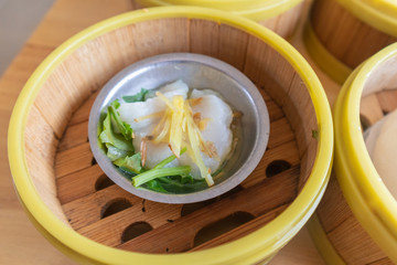 close up of steamed fish in bamboo basket