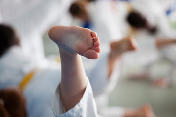 Foot of the child during training of judo in a gym