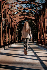 Young woman walks over an old bridge in Slovenia