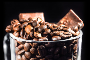 coffee grain and chocolate on dark background, close up