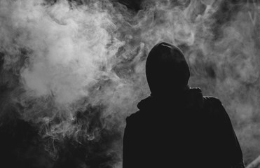 silhouette of a guy in the smoke