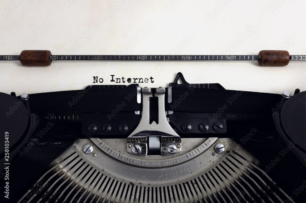 Fototapete old retro vintage black typewriter with close-up typing text no internet as heading on aged paper