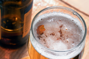 glass of beer with on a wooden stand