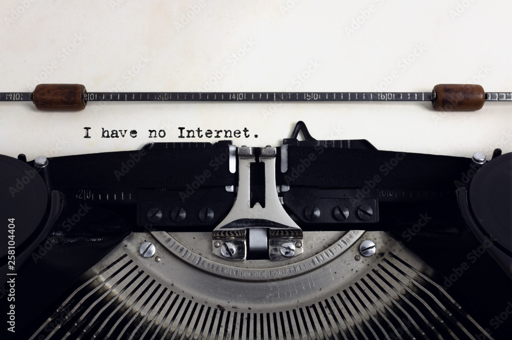 Fototapete old retro vintage black typewriter with close-up typing text i have no internet as heading on aged p