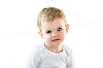 cute child with blonde hair looking at camera isolated on white