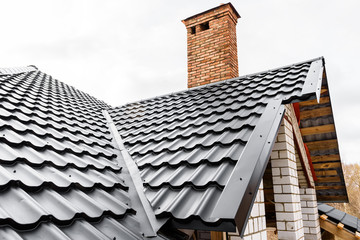 Construction of the roof of the house. Metal tiles.