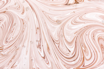 The process of mixing white and light brown paint close-up. Empty abstract background for layouts.